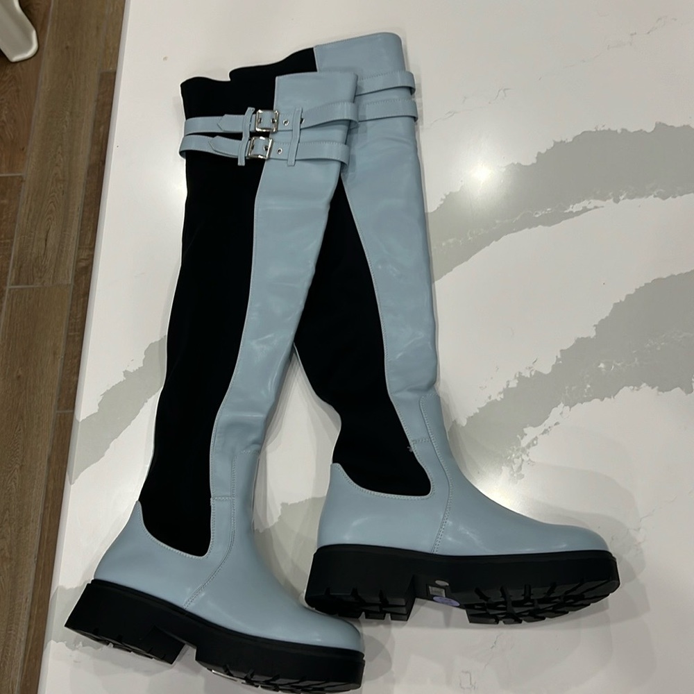 Light blue lug sole over the knee rainboots for rainy season.